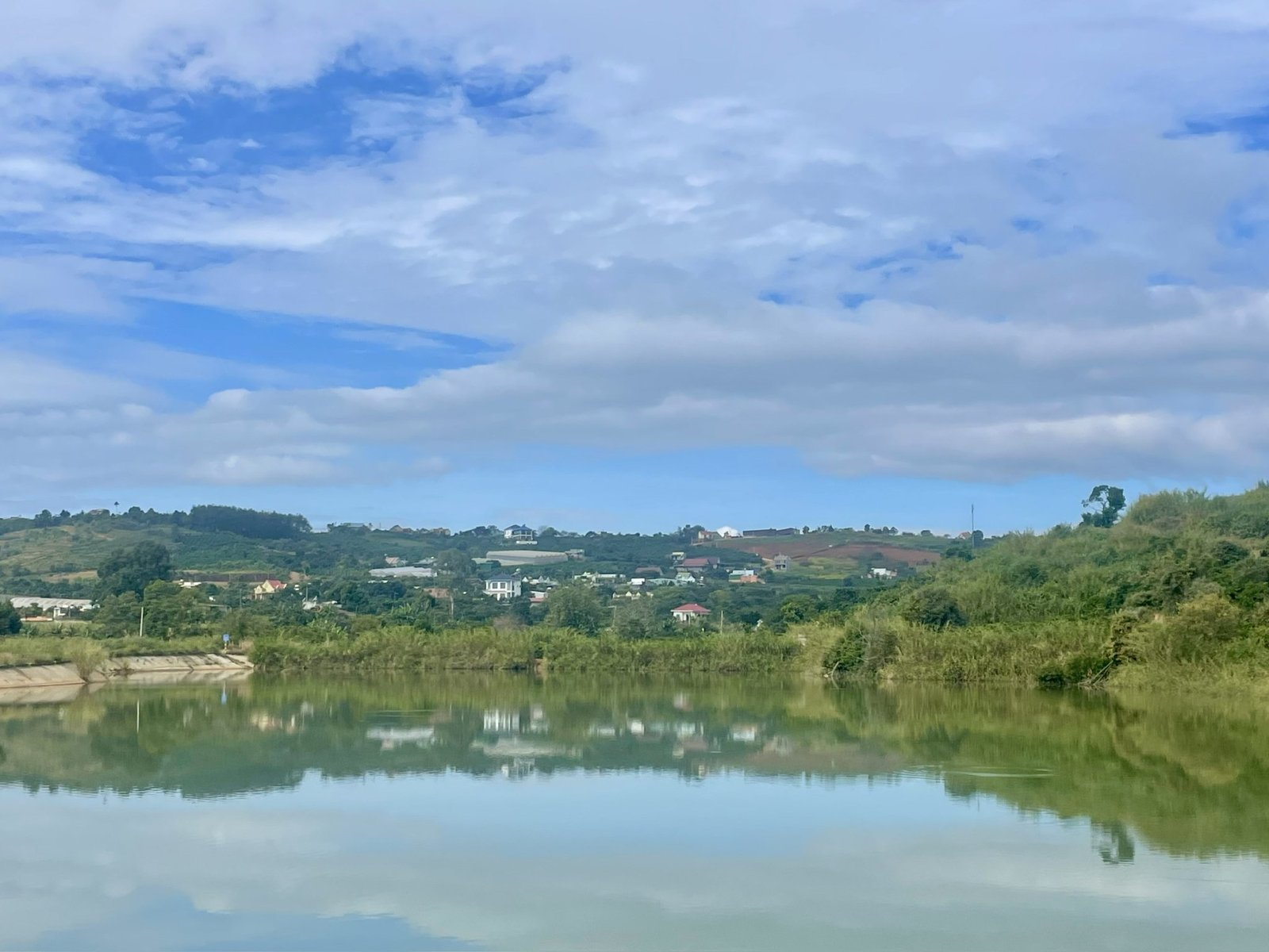 Hồ Bãi Công ban ngày, nhà và villa trên đồi bờ bên kia